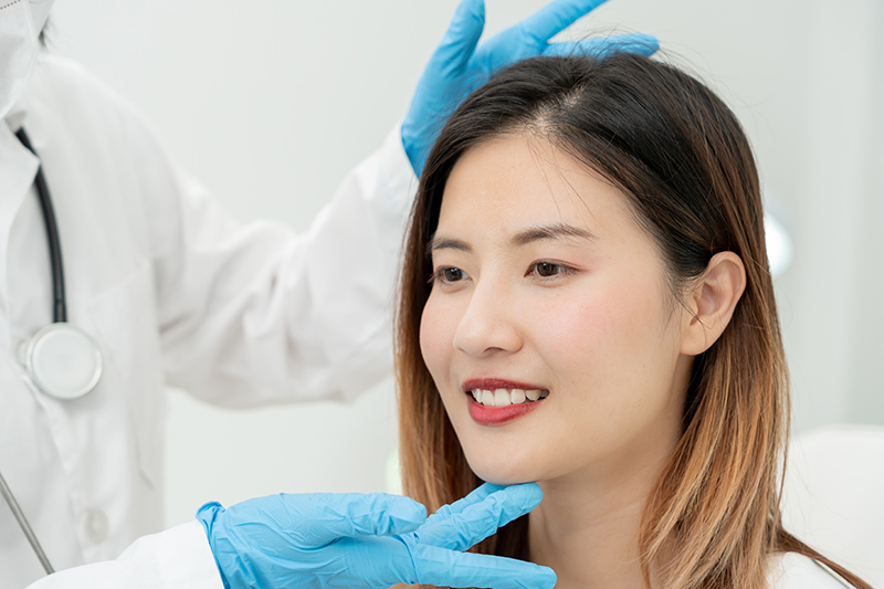 A woman being examined by her plastic surgeon