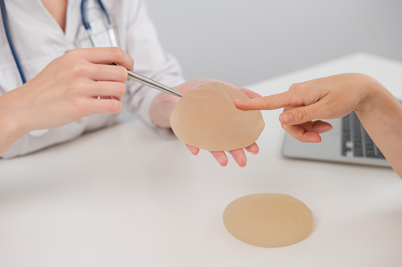 A patient discussing breast augmentation implants with her cosmetic surgeon