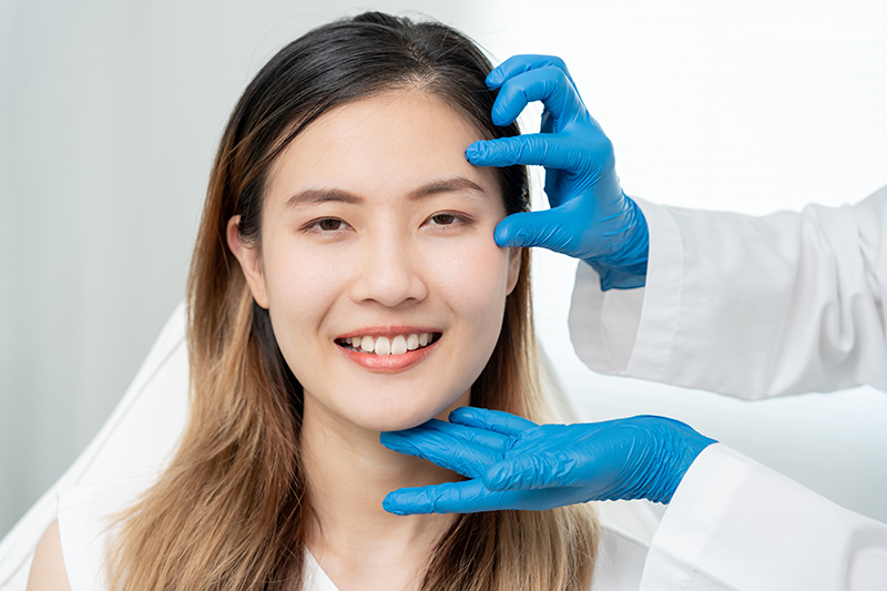 A woman receiving a consultation for eyelid surgery