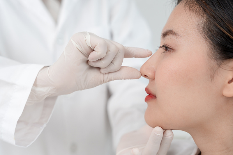 A plastic surgeon planning out a procedure for a patient